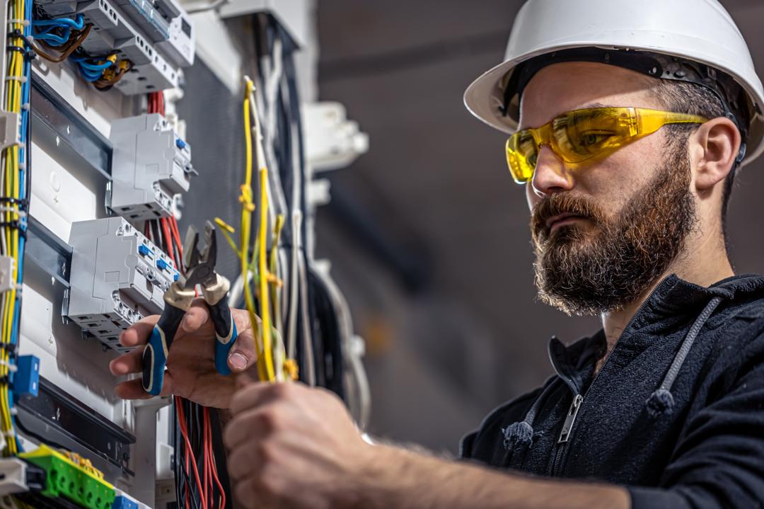 Electrician wiring a commercial breaker panel